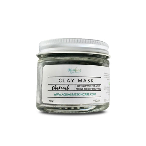 Aqualime Charcoal Clay Mask in a 2 oz glass bottle against a clean white background, showcasing its simple, sleek design and natural ingredients for skin detoxification