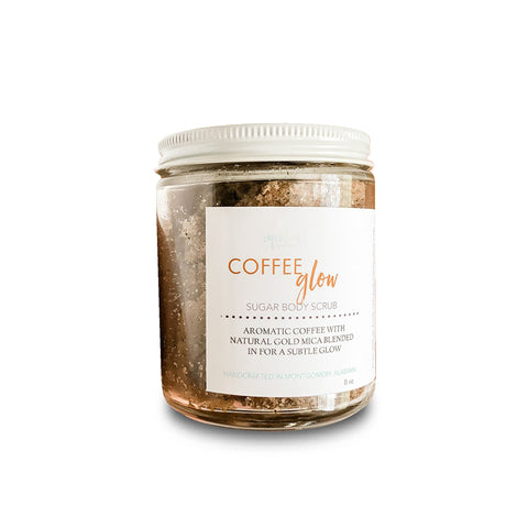 Aqualime Coffee Glow Shimmering Sugar Body Scrub in a glass bottle against a clean white background, highlighting its natural coffee, cinnamon, and gold mica ingredients for glowing skin