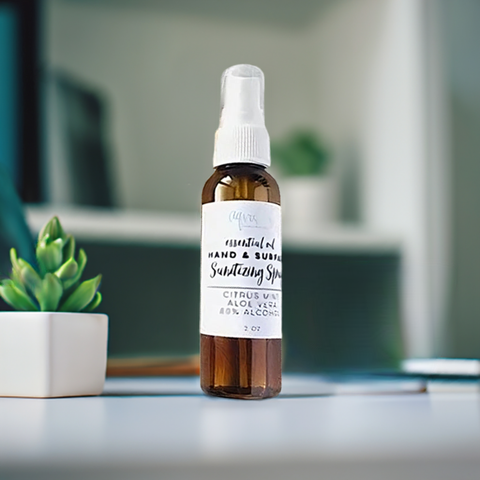 Aqualime Hand and Surface Sanitizing Spray bottle placed on a white background with a clean, minimalistic cabinet, highlighting its sleek and hygienic design