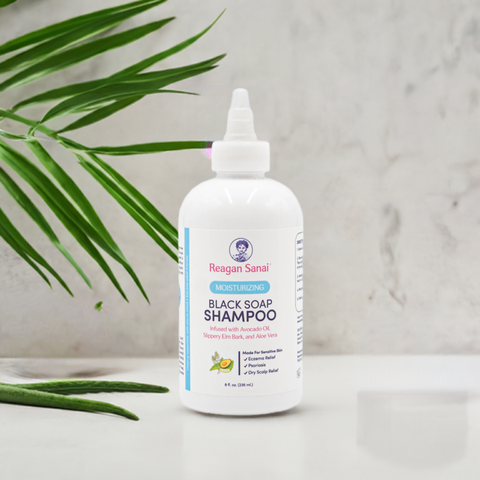 Reagan Sanai Moisturizing Black Soap Shampoo bottle with fresh background and aloe vera leaf, perfect for nourishing and cleansing curly hair