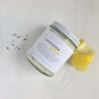 Aqualime Coffee Glow Shimmering Sugar Body Scrub in a glass bottle placed on a white background with a fresh lemon, highlighting its invigorating and aromatic formula