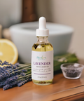 Aqualime Lavender Bath and Body Oil bottle placed on a wooden table with a cut lemon, highlighting its refreshing, hydrating, and natural ingredients.