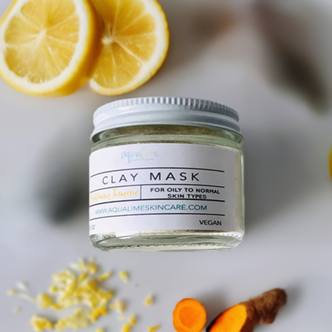 Aqualime Turmeric and Clay Facial Mask bottle placed alongside turmeric roots and cut lemon, emphasizing its brightening and skin-rejuvenating benefits