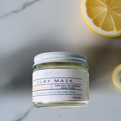 Aqualime Turmeric and Clay Facial Mask bottle placed on a white background with cut lemon, showcasing its brightening and skin-rejuvenating properties